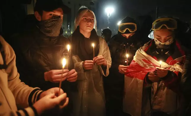 Demonstrators pray during a rally outside the parliament to protest against the government's decision to suspend negotiations on joining the European Union in Tbilisi, Georgia, on Tuesday, Dec. 3, 2024. (AP Photo/Zurab Tsertsvadze)