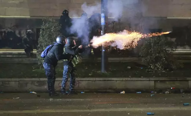 Police officers launch tear gas grenades towards demonstrators protesting against the government's decision to suspend negotiations on joining the European Union in Tbilisi, Georgia, early Tuesday, Dec. 3, 2024. (AP Photo/Zurab Tsertsvadze)