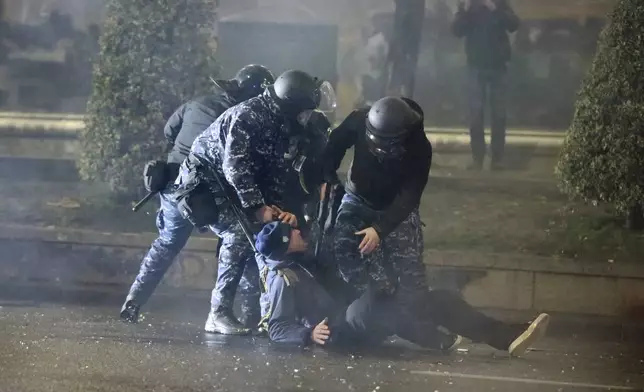 Police detain a demonstrator during a protest against the government's decision to suspend negotiations on joining the European Union in Tbilisi, Georgia, on Tuesday, Dec. 3, 2024. (AP Photo/Zurab Tsertsvadze)