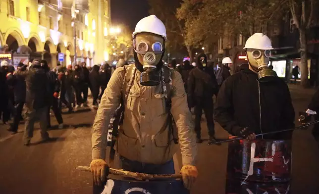 Demonstrators participate in a rally to protest against the government's decision to suspend negotiations on joining the European Union in Tbilisi, Georgia, early Wednesday, Dec. 4, 2024. (AP Photo/Zurab Tsertsvadze)