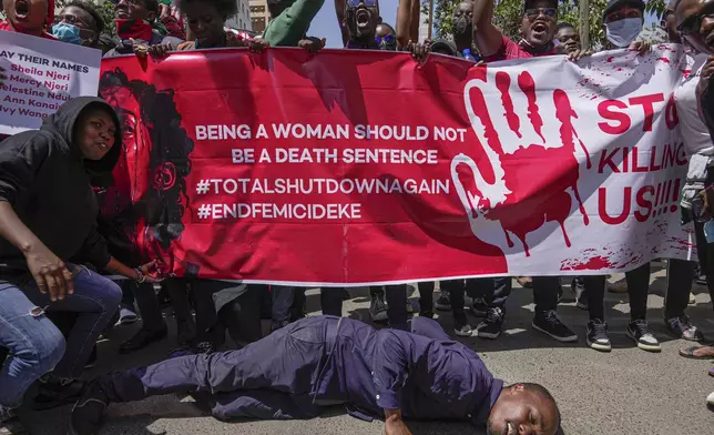 Demonstrators hold placards during a march against the rising cases of femicide, in downtown Nairobi, Kenya, Tuesday, Dec. 20, 2024. (AP Photo/Brian Inganga)