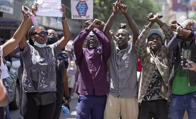 Demonstrators chant during a march against the rising cases of femicide, in downtown Nairobi, Kenya, Tuesday, Dec. 10, 2024. (AP Photo/Brian Inganga)