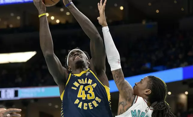 Indiana Pacers forward Pascal Siakam (43) shoots against Memphis Grizzlies guard Ja Morant, right, in the first half of an NBA basketball game Sunday, Dec. 1, 2024, in Memphis, Tenn. (AP Photo/Brandon Dill)