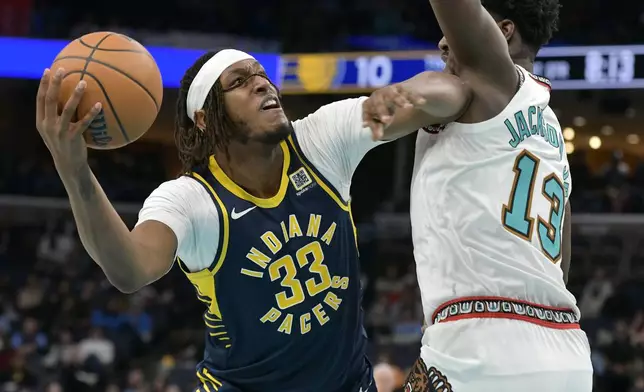 Indiana Pacers center Myles Turner (33) looks to shoot against Memphis Grizzlies forward Jaren Jackson Jr. (13) in the first half of an NBA basketball game Sunday, Dec. 1, 2024, in Memphis, Tenn. (AP Photo/Brandon Dill)