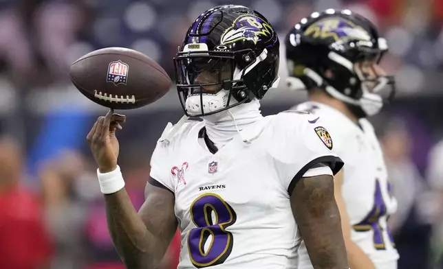 Baltimore Ravens quarterback Lamar Jackson warms up before an NFL football game against the Houston Texans, Wednesday, Dec. 25, 2024, in Houston. (AP Photo/David J. Phillip)