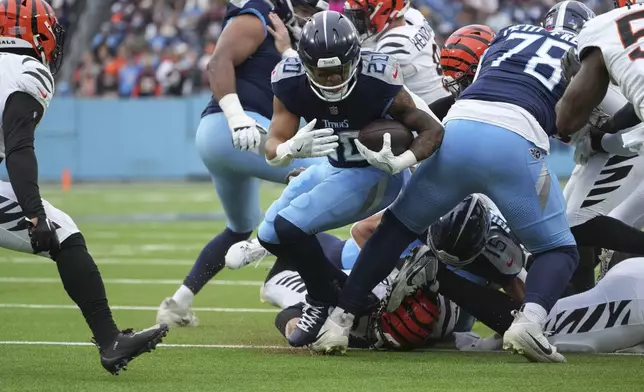 Tennessee Titans running back Tony Pollard (20) runs for a first down during the first half of an NFL football game against the Cincinnati Bengals, Sunday, Dec. 15, 2024, in Nashville, Tenn. (AP Photo/George Walker IV)