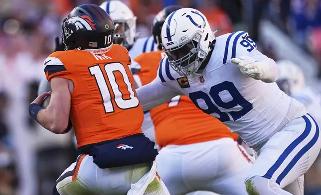 Indianapolis Colts' DeForest Buckner sacks Denver Broncos' Bo Nix in the first half of an NFL football game Sunday, Dec. 15, 2024, in Denver. (AP Photo/David Zalubowski)