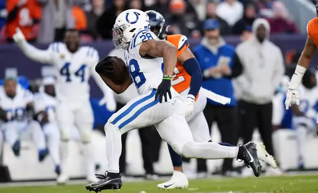 Indianapolis Colts' Jonathan Taylor runs for what would have been a touchdown during the second half of an NFL football game against the Denver Broncos Sunday, Dec. 15, 2024, in Denver. Taylor dropped the ball before crossing the goal line. (AP Photo/Jack Dempsey)