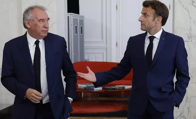 FILE - French President Emmanuel Macron, right, meets French centrist party MoDem (Mouvement Democrate) leader Francois Bayrou at the Elysee Palace in Paris, France, Tuesday, June 21, 2022. French President Emmanuel Macron names key centrist ally François Bayrou as new prime minister Friday Dec.13 2024. (Ludovic Marin/Pool photo via AP, File)