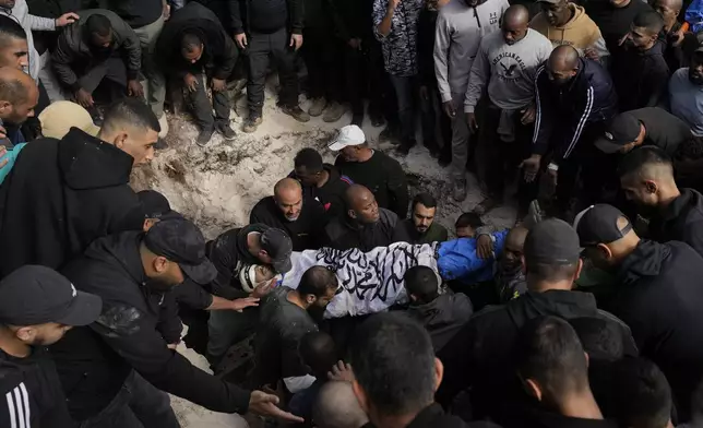 A Palestinian killed during an Israeli army operation is buried in the West Bank city of Tulkarem, Thursday, Dec. 26, 2024. (AP Photo/Matias Delacroix)