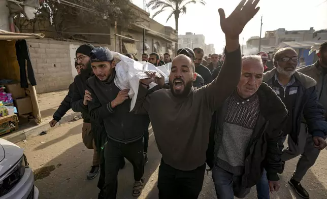 Mourners react as they carry the bodies of five Palestinian journalists who were killed by an Israeli airstrike in Gaza City at the Al-Aqsa Hospital in Deir al-Balah, Thursday, Dec. 26, 2024. (AP Photo/Abdel Kareem Hana)