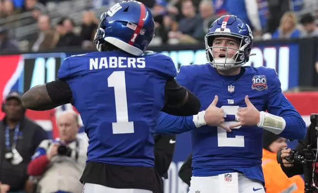 New York Giants quarterback Drew Lock (2) celebrates with wide receiver Malik Nabers (1) after Lock ran for a touchdown against the Indianapolis Colts in the second half of an NFL football game Sunday, Dec. 29, 2024, in East Rutherford, N.J. (AP Photo/Seth Wenig)