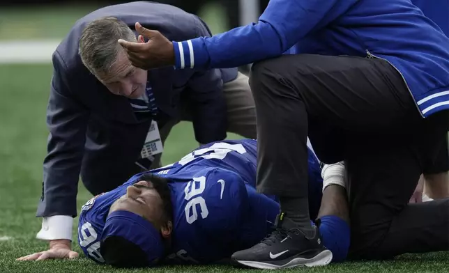 New York Giants defensive tackle Armon Watts (96) is attended to after being injured in the first half of an NFL football game against the Indianapolis Colts Sunday, Dec. 29, 2024, in East Rutherford, N.J. (AP Photo/Seth Wenig)