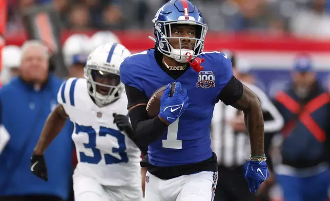 New York Giants wide receiver Malik Nabers (1) scores his second touchdown of the game against the Indianapolis Colts in the second half of an NFL football game Sunday, Dec. 29, 2024, in East Rutherford, N.J. (AP Photo/Corey Sipkin)