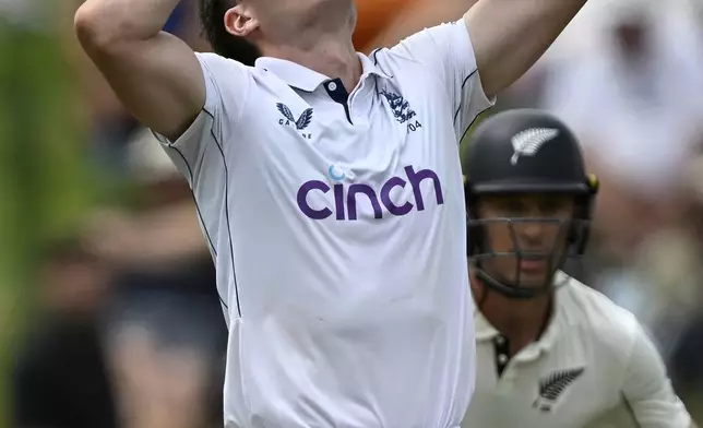 England bowler Matthew Potts reacts during play on day one of the third cricket test between England and New Zealand in Hamilton, New Zealand, Saturday, Dec. 14, 2024. (Andrew Cornaga/Photosport via AP)