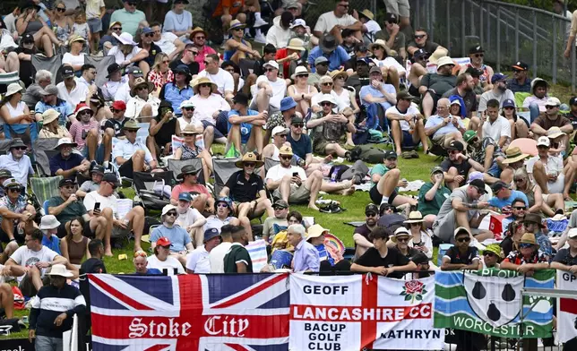 Spectators watch play on day one of the third cricket test between England and New Zealand in Hamilton, New Zealand, Saturday, Dec. 14, 2024. (Andrew Cornaga/Photosport via AP)