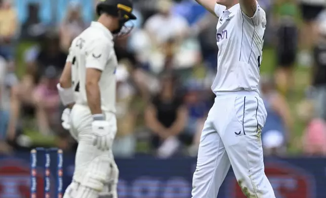 England bowler Matthew Potts reacts during play on day one of the third cricket test between England and New Zealand in Hamilton, New Zealand, Saturday, Dec. 14, 2024. (Andrew Cornaga/Photosport via AP)