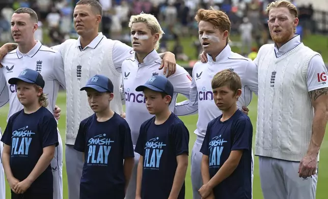 England players react during their national anthemn ahead of play on day one of the third cricket test between England and New Zealand in Hamilton, New Zealand, Saturday, Dec. 14, 2024. (Andrew Cornaga/Photosport via AP)