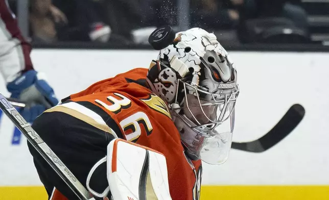 Anaheim Ducks goaltender John Gibson (36) blocks a shot during the second period of an NHL hockey game against the Colorado Avalanche, Friday, Dec. 20, 2024, in Anaheim, Calif. (AP Photo/Kyusung Gong)