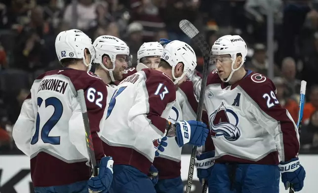 Colorado Avalanche players celebrate after a goal by right wing Valeri Nichushkin (13) during the second period of an NHL hockey game against the Anaheim Ducks, Friday, Dec. 20, 2024, in Anaheim, Calif. (AP Photo/Kyusung Gong)