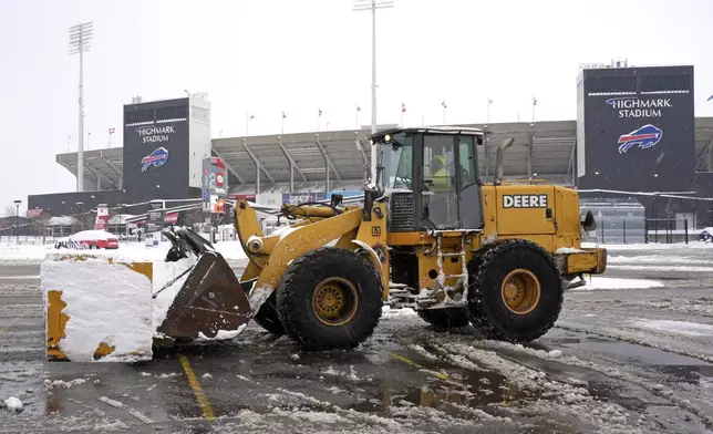 Snow is cleared from a Highmark Stadium parking lot for a Sunday Night Football game between the Buffalo Bills and the San Francisco 49ers on Sunday, Dec. 1, 2024 in Orchard Park, N.Y. (AP Photo/Gene J. Puskar)