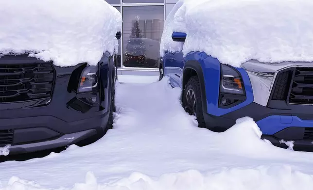 Vehicles are covered during a snow storm in Lowville, N.Y., on Sunday Dec, 1, 2024. (AP Photo/Cara Anna)