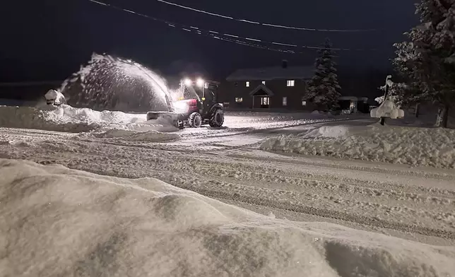 A snowplow operates in Lowville, N.Y., on Sunday, Dec. 1, 2024. (AP Photo/Cara Anna)