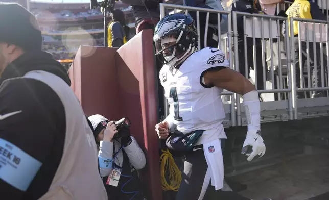 Philadelphia Eagles quarterback Jalen Hurts (1) taking the field before the start of an NFL football game against the Washington Commanders, Sunday, Dec. 22, 2024, in Landover, Md. (AP Photo/Stephanie Scarbrough)