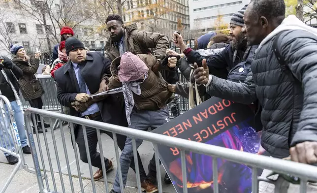A person protesting the not guilty verdict of Daniel Penny is arrested by police outside the criminal court, Monday, Dec. 9, 2024, in New York. (AP Photo/Stefan Jeremiah)