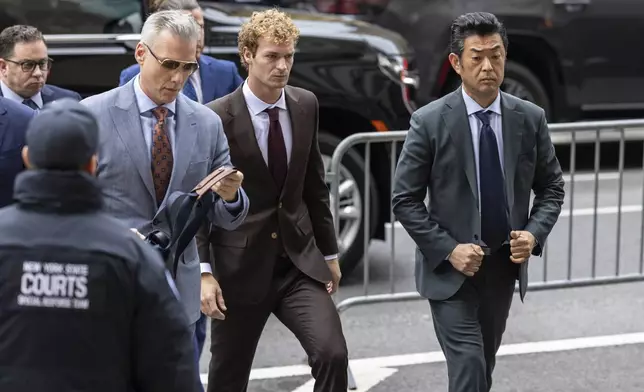 Daniel Penny, center, arrives at criminal court, Monday, Dec. 9, 2024, in New York. (AP Photo/Stefan Jeremiah)