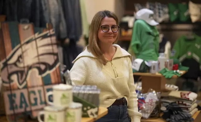 Nicole Beltz poses for a photograph at her shop, Serendipity, Wednesday, Dec. 11, 2024, in Philadelphia. (AP Photo/Matt Slocum)