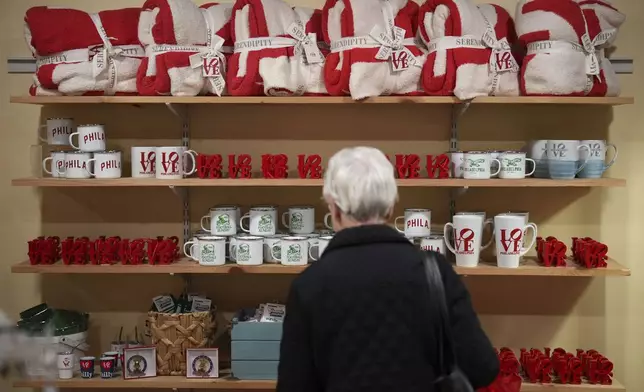 A person shops at Serendipity, Wednesday, Dec. 11, 2024, in Philadelphia. (AP Photo/Matt Slocum)