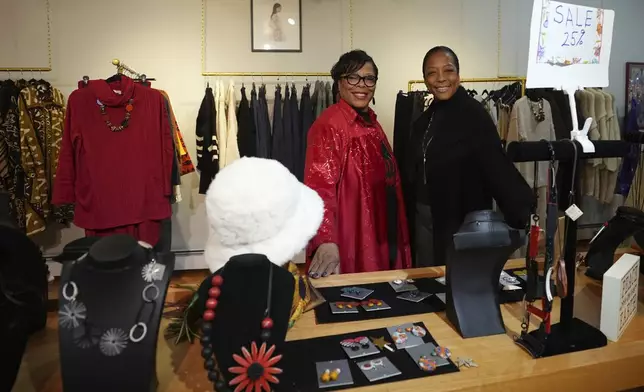 Claudia Averette, left, and her daughter, Atiya Smith pose for a photograph at their shop, Between Friends Boutique, Wednesday, Dec. 11, 2024, in Philadelphia. (AP Photo/Matt Slocum)