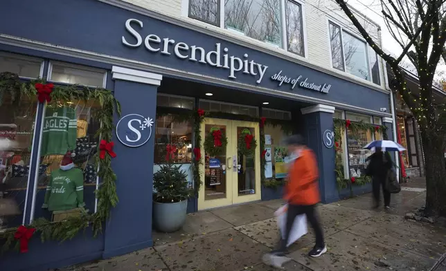 People walk past Serendipity, Wednesday, Dec. 11, 2024, in Philadelphia. (AP Photo/Matt Slocum)