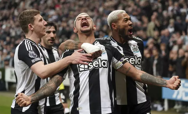 Newcastle United's Bruno Guimaraes, centre, celebrates scoring his side's third goal of the game only to see it ruled out by VAR , during the English Premier League soccer match between Newcastle United and Aston Villa at St. James' Park, in Newcastle upon Tyne, England, Thursday, Dec. 26, 2024. (Owen Humphreys/PA via AP)