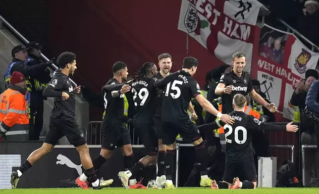 West Ham United's Jarrod Bowen, bottom right, celebrates scoring their side's first goal of the game during the Premier League match at St Mary's Stadium, in Southampton, England, Thursday Dec. 26, 2024. (Andrew Matthews/PA via AP)