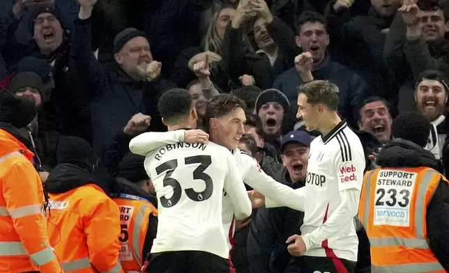 Fulham's Harry Wilson, center, celebrates after scoring his sides first goal during the English Premier League soccer match between Chelsea and Fulham at Stamford Bridge stadium in London, Thursday, Dec. 26, 2024. (AP Photo/Kirsty Wigglesworth)