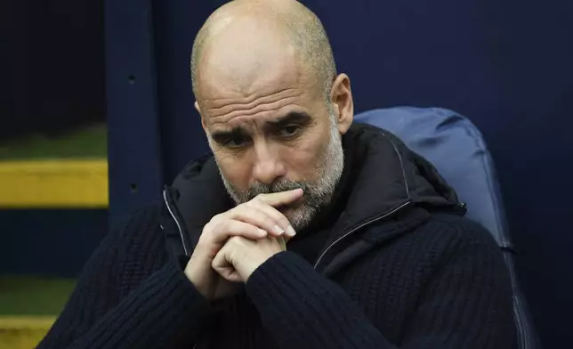 Manchester City's head coach Pep Guardiola sits on the bench prior to the English Premier League soccer match between Manchester City and Everton at the Etihad stadium in Manchester, Thursday, Dec. 26, 2024. (AP Photo/Rui Vieira)