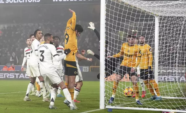 Wolverhampton Wanderers' Matheus Cunha, not in the picture, scores the opening goal during the English Premier League soccer match between Wolverhampton Wanderers and Manchester United at the Molineux Stadium, Wolverhampton, England, Thursday, Dec. 26, 2024. (David Davies/PA via AP)