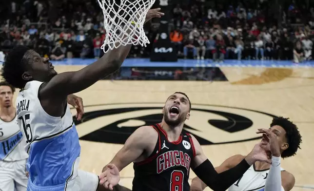 Chicago Bulls guard Zach LaVine (8) shoots against Atlanta Hawks center Clint Capela (15) during the first half of an NBA basketball game, Thursday, Dec. 26, 2024, in Atlanta. (AP Photo/Mike Stewart)