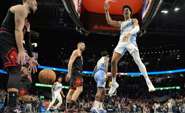 Atlanta Hawks forward Jalen Johnson (1) celebrates a dunk against against the Chicago Bulls in the closing seconds during the second half of an NBA basketball game, Thursday, Dec. 26, 2024, in Atlanta. (AP Photo/Mike Stewart)