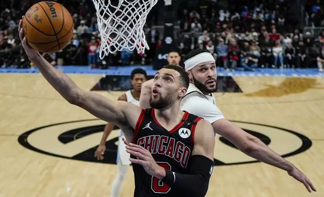 Chicago Bulls guard Zach LaVine (8) shoots against Atlanta Hawks forward Larry Nance Jr. (22) during the first half of an NBA basketball game, Thursday, Dec. 26, 2024, in Atlanta. (AP Photo/Mike Stewart)