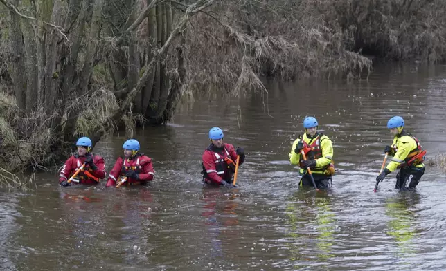 Members of a search and rescue team conduct a search operation at Abberwick Ford on the River Aln near Alnwick, north of Newcastle, England for former England rugby player Tom Voyce who is missing, Wednesday, Dec. 11, 2024. (Owen Humphreys/PA via AP)