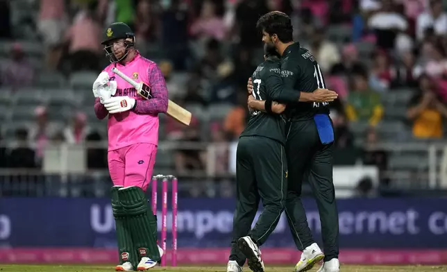 Pakistan's Shaheen Shah Afridi, right, celebrates with teammate Salman Ali Agha, after dismissing South Africa's Heinrich Klaasen for 81 runs during the third International cricket match between South Africa and Pakistan, at the Wanderers stadium in Johannesburg, South Africa, Sunday, Dec. 22, 2024. (AP Photo/Themba Hadebe)