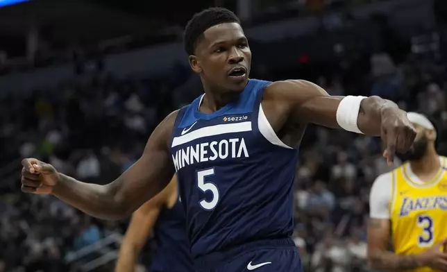 Minnesota Timberwolves guard Anthony Edwards (5) reacts after making a basket and being fouled during the first half of an NBA basketball game against the Los Angeles Lakers, Friday, Dec. 13, 2024, in Minneapolis. (AP Photo/Abbie Parr)