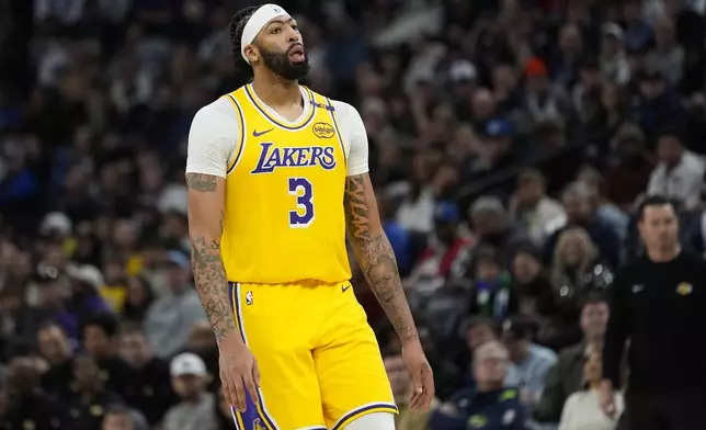 Los Angeles Lakers forward Anthony Davis reacts after missing a basket during the second half of an NBA basketball game against the Minnesota Timberwolves, Friday, Dec. 13, 2024, in Minneapolis. (AP Photo/Abbie Parr)