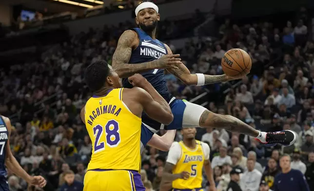 Minnesota Timberwolves guard Nickeil Alexander-Walker, top, looks to pass the ball as Los Angeles Lakers forward Rui Hachimura (28) defends during the first half of an NBA basketball game, Friday, Dec. 13, 2024, in Minneapolis. (AP Photo/Abbie Parr)