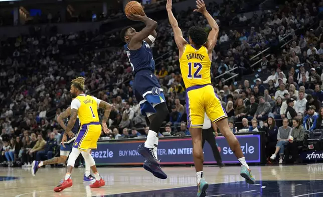 Minnesota Timberwolves guard Anthony Edwards (5) shoots over Los Angeles Lakers guard Max Christie (12) during the first half of an NBA basketball game, Friday, Dec. 13, 2024, in Minneapolis. (AP Photo/Abbie Parr)