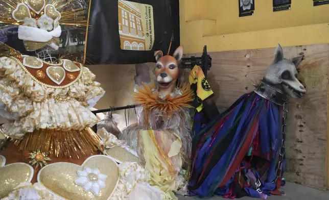 Carnival costumes sit at the Sao Clemente samba school, whose theme for 2025 is animal abuse and abandonment, in Rio de Janeiro, Thursday, Nov. 28, 2024. (AP Photo/Silvia Izquierdo)