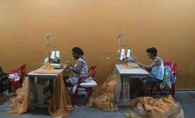 Sao Clemente samba school seamstresses make costumes for Carnival, in Rio de Janeiro, Thursday, Nov. 28, 2024. (AP Photo/Silvia Izquierdo)